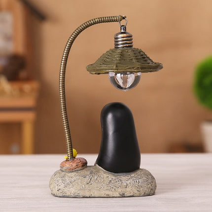 Dekorativ lampe med Uten-ansikt figur
